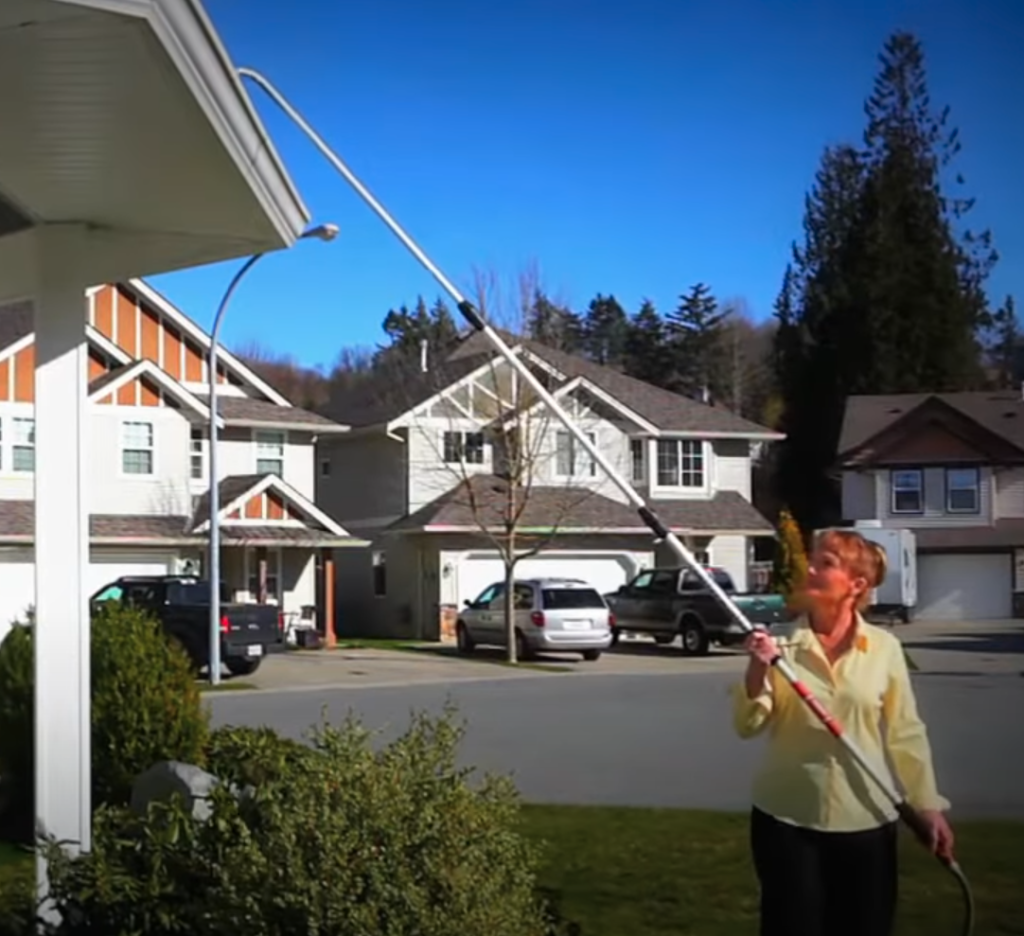 Woman Washes out Gutter with Guttermaster Tools